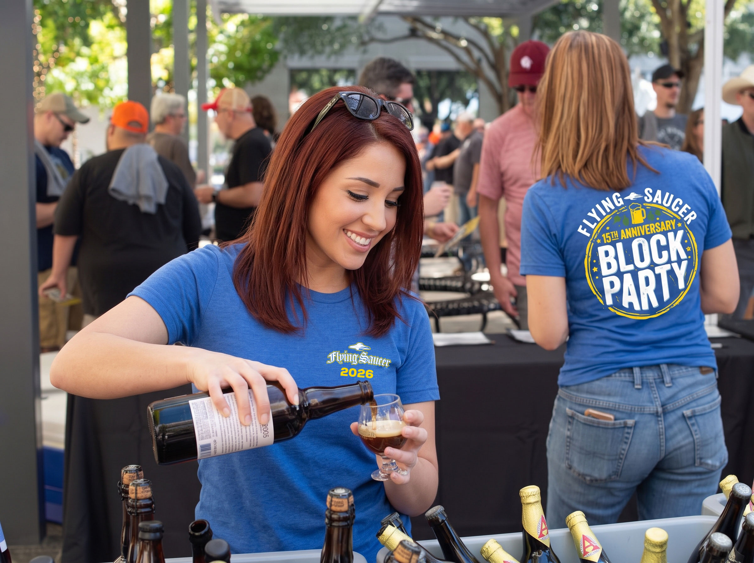 Flying Saucer Block party two women wearing blue shirts pouring beverages